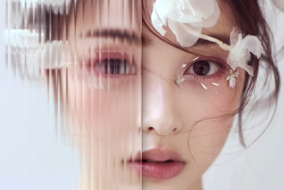Close-up of woman's face with white flowers, left side blurred through vertical lines