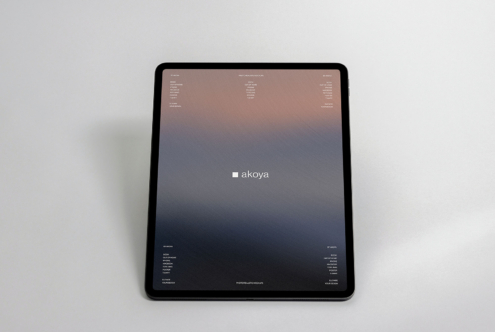 iPad on neutral background showing Akoya brand interface with gradient design
