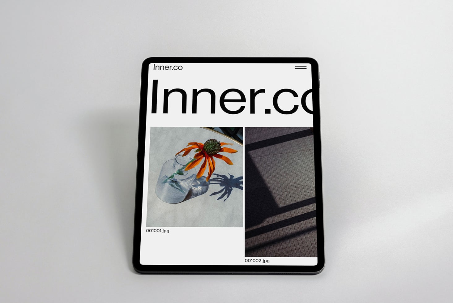 iPad displaying Inner.co website with portfolio layout featuring colorful flower imagery