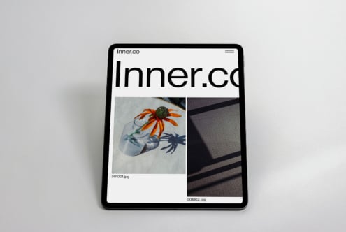iPad displaying Inner.co website with portfolio layout featuring colorful flower imagery