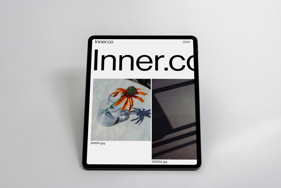 iPad displaying Inner.co website with portfolio layout featuring colorful flower imagery