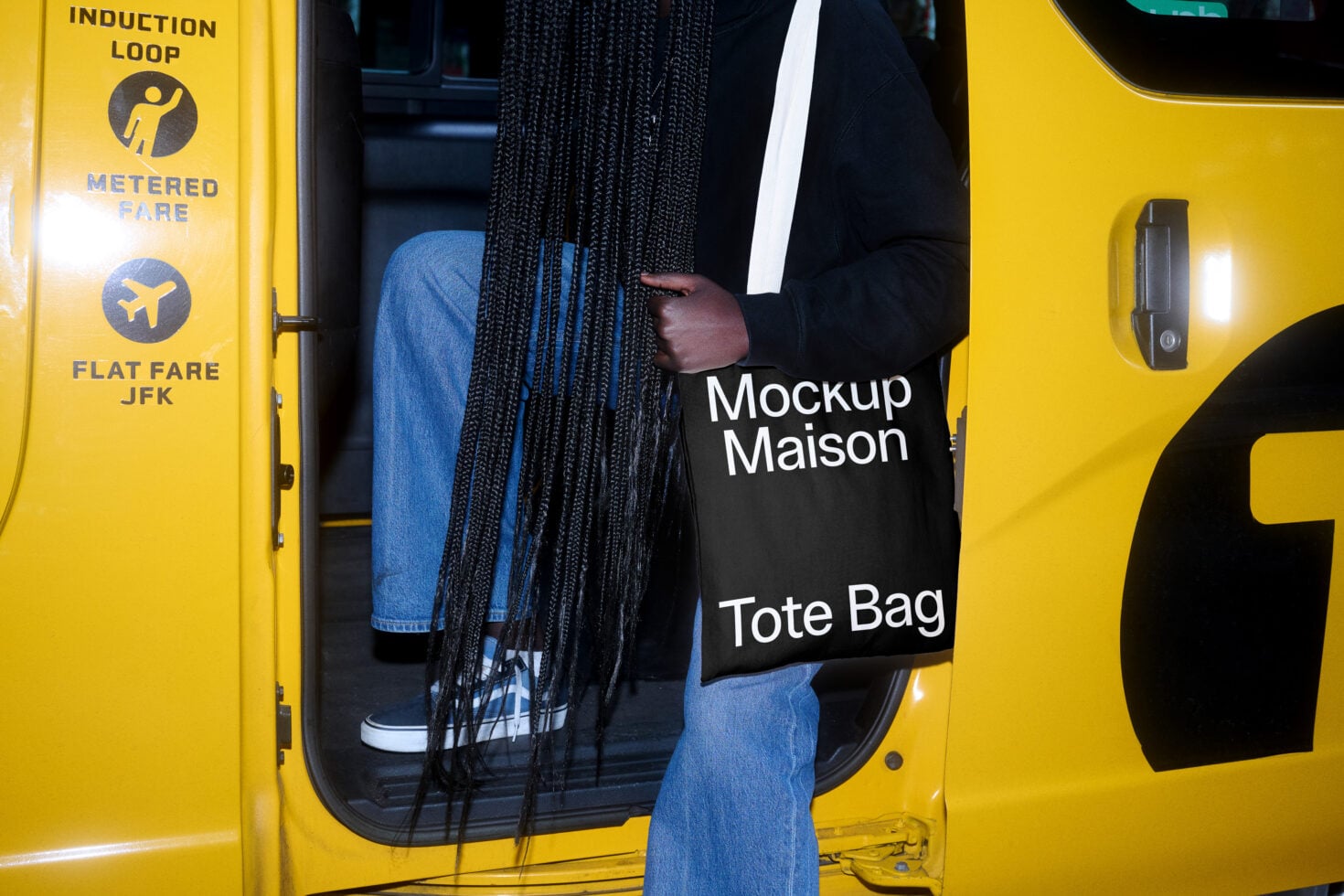 White tote bag mockup held on yellow NYC taxi with braided hair visible