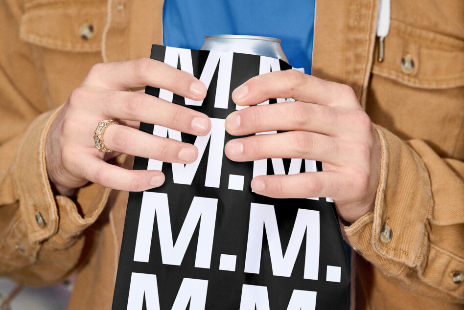 Hands holding aluminum can with black white geometric pattern design