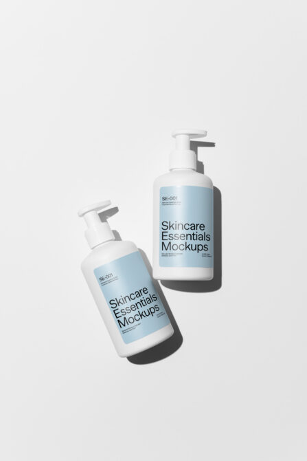 Two white pump bottles in angled view with blue label mockups for skincare