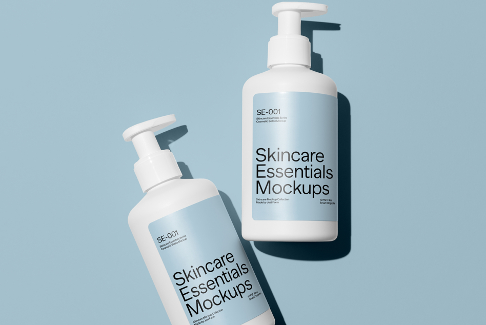 Two white pump bottles with blue labels on soft blue background casting shadows