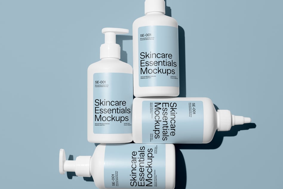 Four cosmetic bottles on blue background showing pump, spray bottle mockup designs