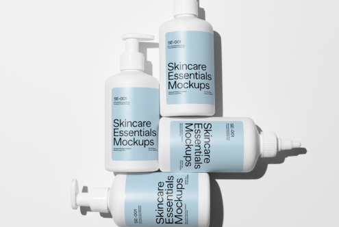 Four cosmetic bottles on light background with Skincare Essentials Mockups labels