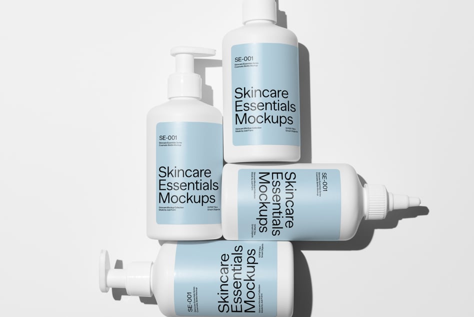 Four cosmetic bottles on light background with Skincare Essentials Mockups labels