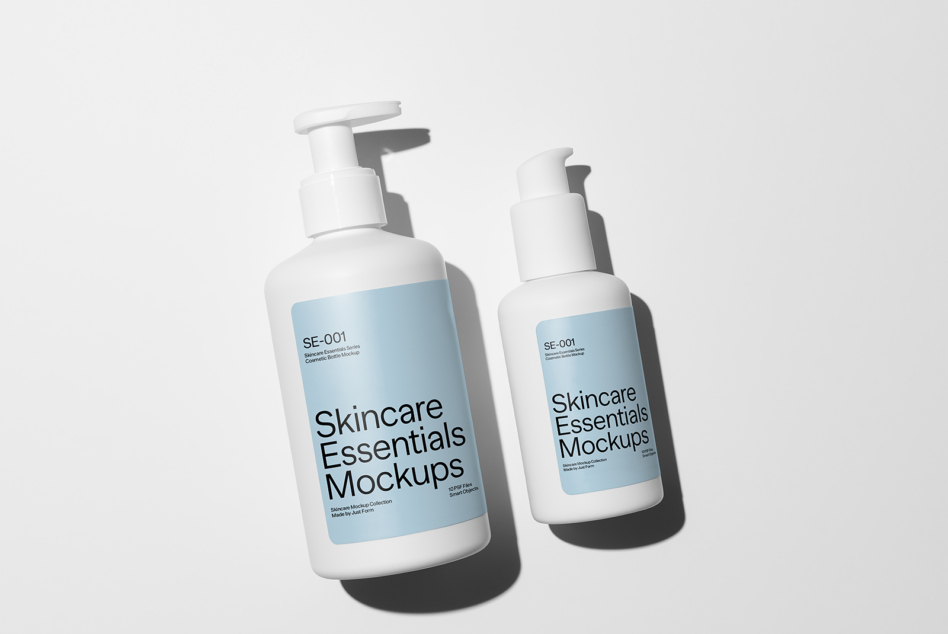 Two white pump bottles with blue label panels showing Skincare Essentials Mockups branding