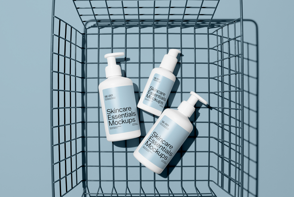 Three pump bottles inside shopping cart on blue background