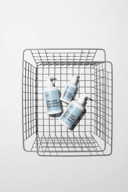 Three cosmetic bottles scattered inside wire shopping cart