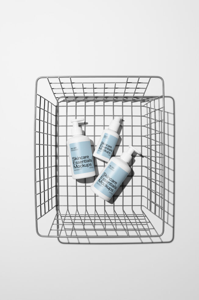 Three cosmetic bottles scattered inside wire shopping cart