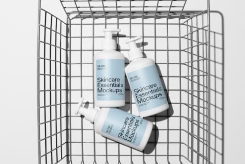 Skincare Essentials Mockups featuring pump bottles with blue labels in a wire basket. Perfect for designers creating beauty product presentations.