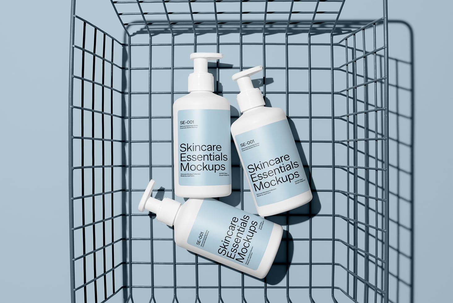 Skincare pump bottles arranged in a wire basket with clean shadows on pale blue background