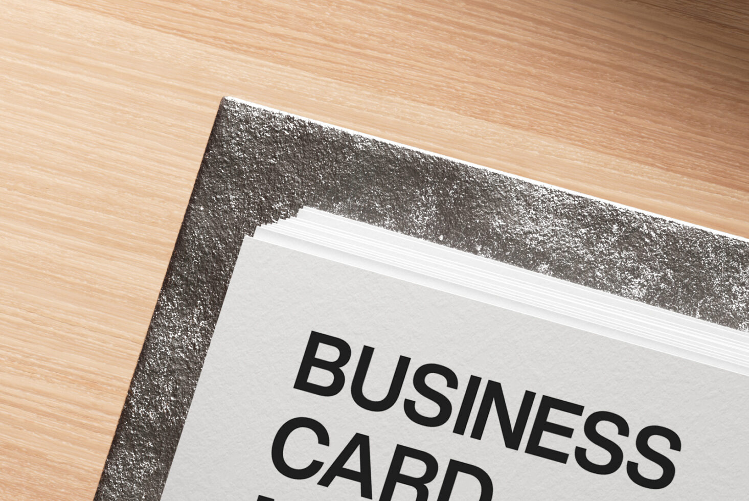Close-up of business card edge showing thick paper stock in holder