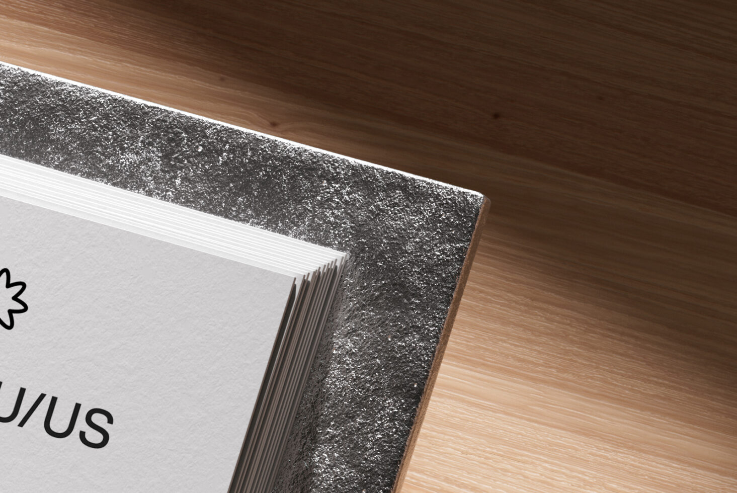 Close-up of textured metallic business card holder edge on wood