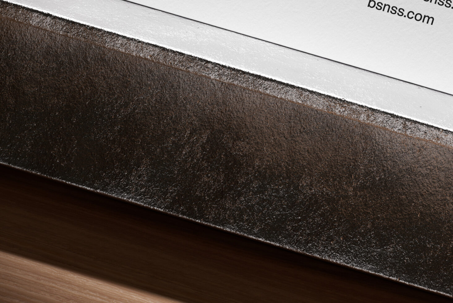 Overhead shot of business cards in dark metallic frame on surface