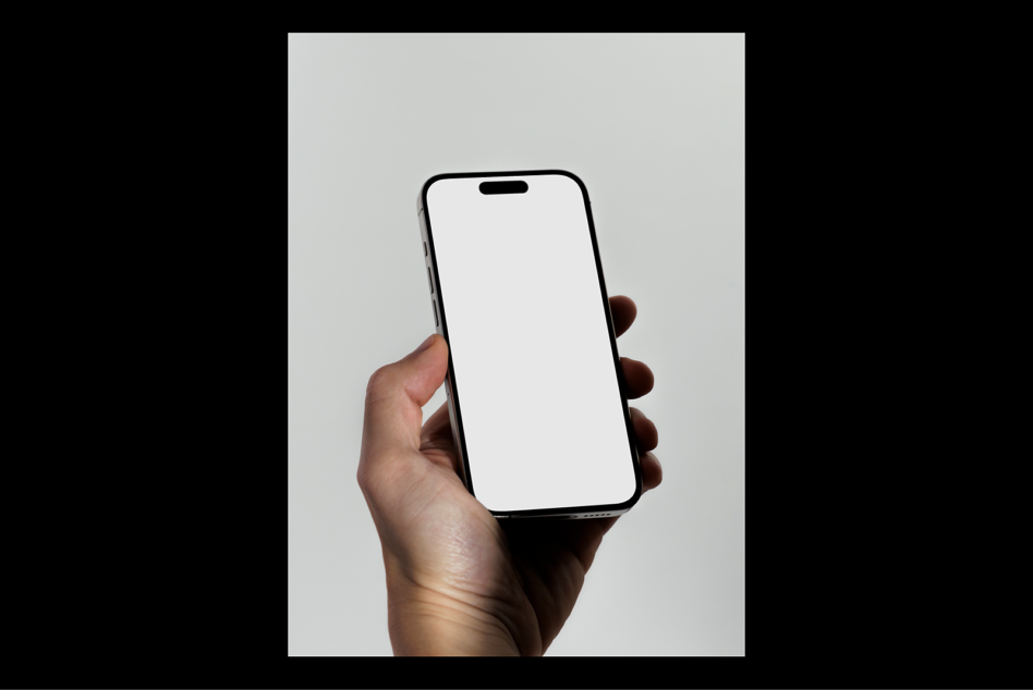 Minimalist smartphone mockup held in hand with blank screen isolated on gray background suitable for app designers and presentations. High-quality image.