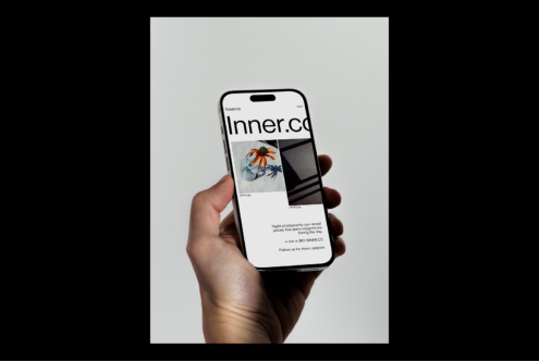 Hand holding smartphone displaying a website. Modern mobile mockup for digital assets, web design, UI, UX, and responsive design templates.