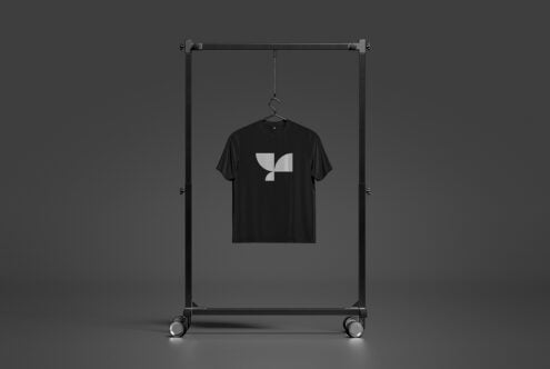 Black shirt with geometric logo on mobile display rack