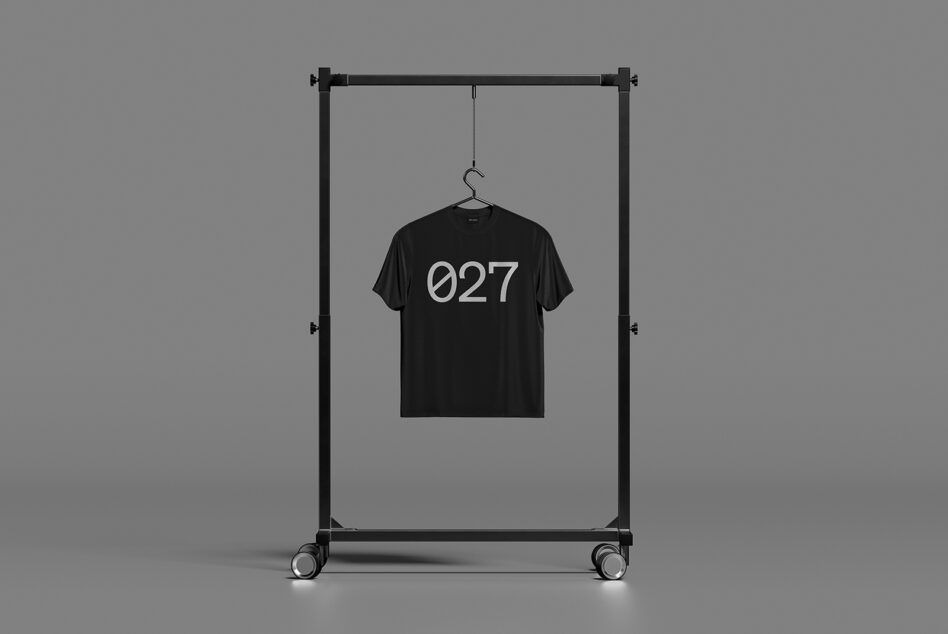 Black tee with 027 hanging on gray rolling garment rack