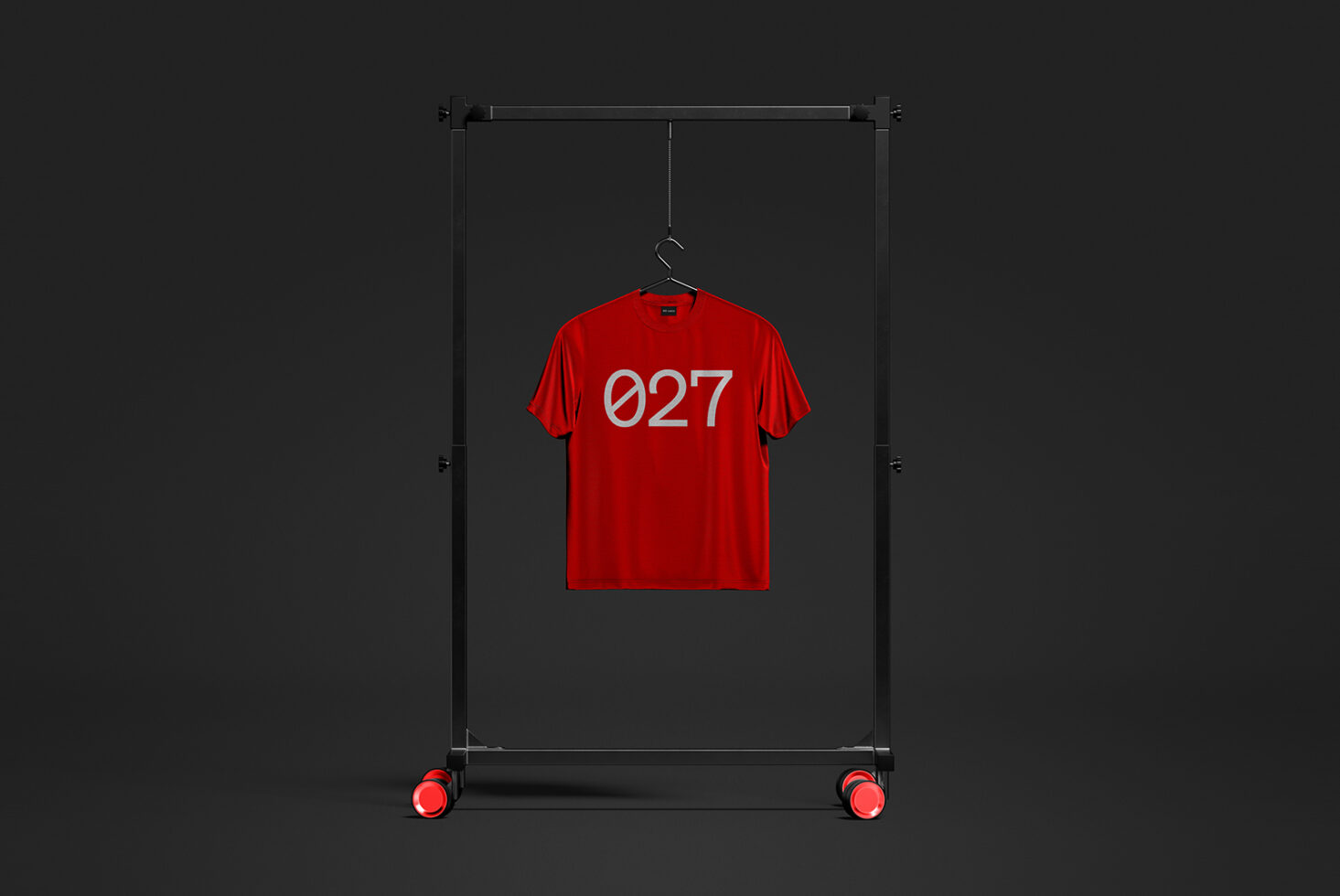 Bright red tee with 027 on display rack against dark background