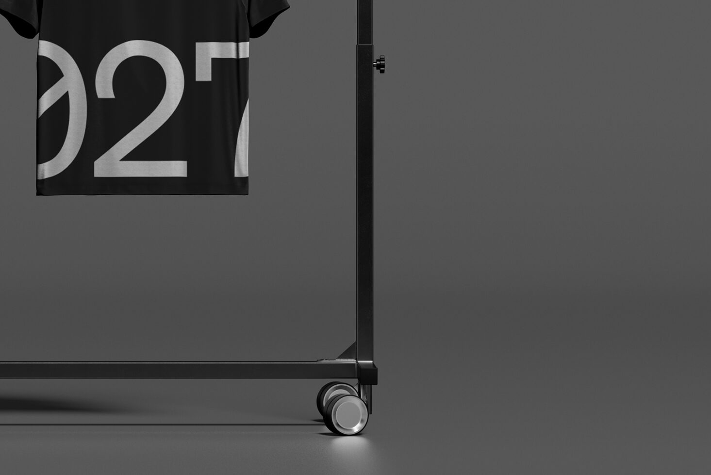 Black shirt on display rack with large metallic numbers printed on fabric close-up