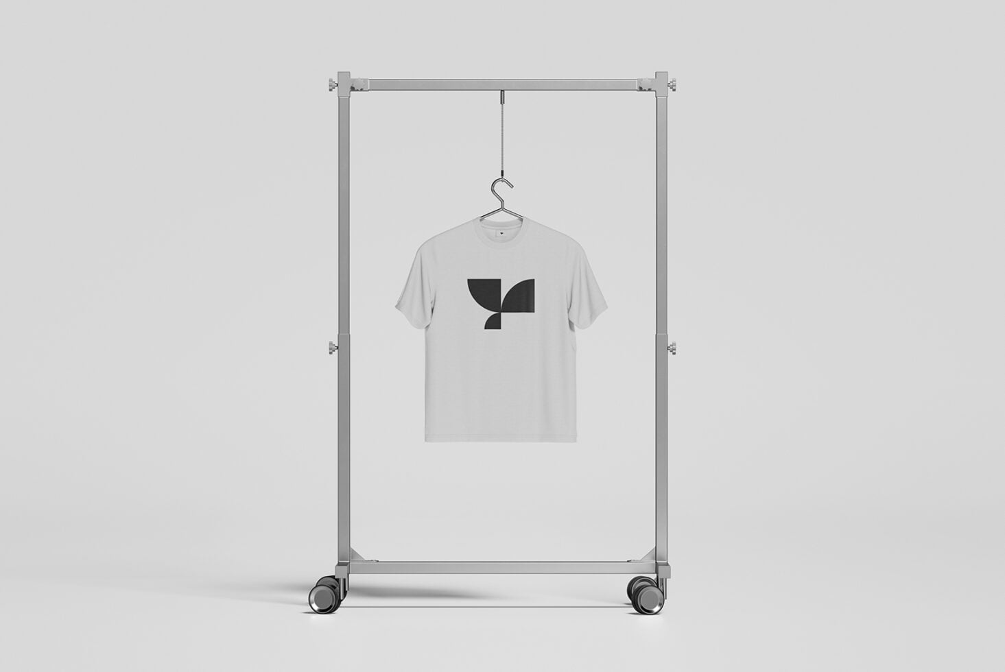 Light grey tee on rolling rack with abstract leaf graphic design