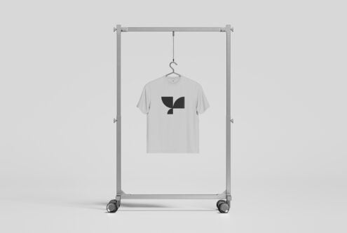 Light grey tee on rolling rack with abstract leaf graphic design