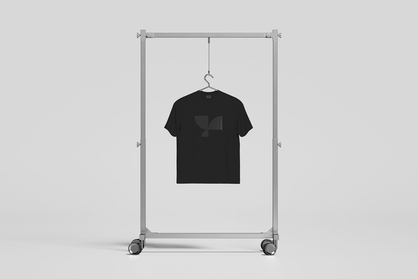 Black tee mockup on rolling rack with geometric logo print