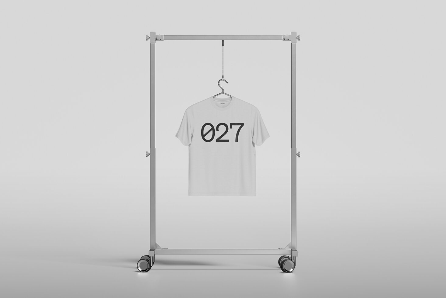 Tee mockup on rolling rack with 027 design centered on chest