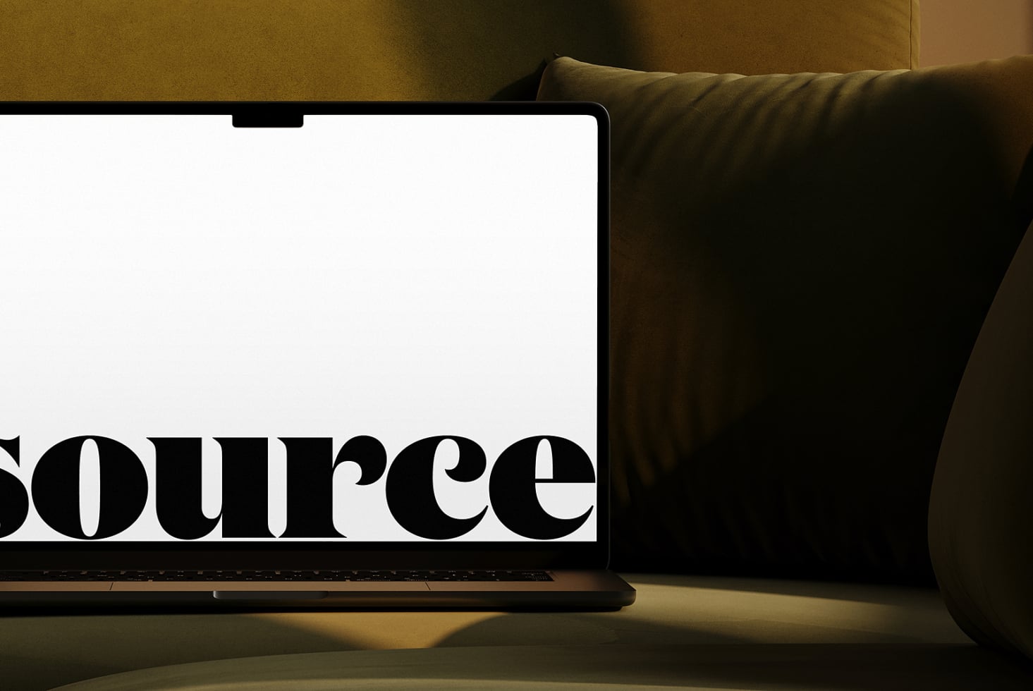 Laptop nestled in olive cushions with bold serif text on display