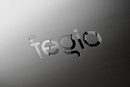 Tegilo text in metallic silver embossed effect on gray metallic surface