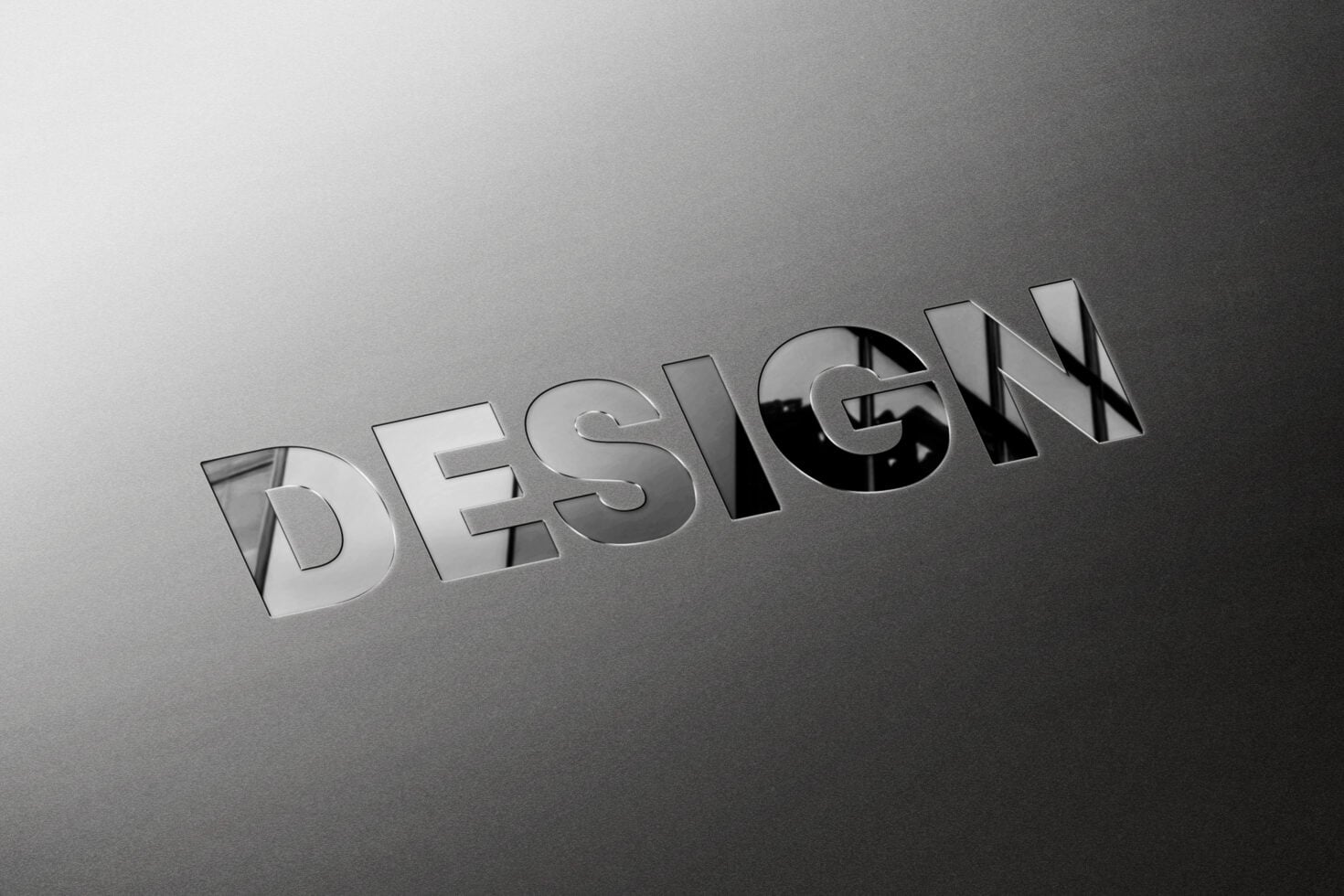 DESIGN text in metallic 3D effect on gray gradient background