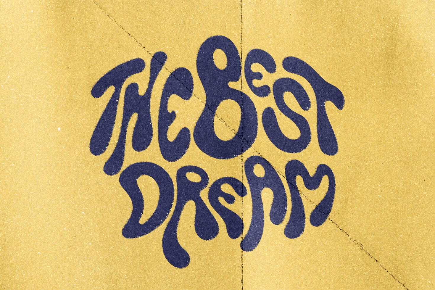 Wavy navy lettering spelling Vibes Dream on yellow paper with creases