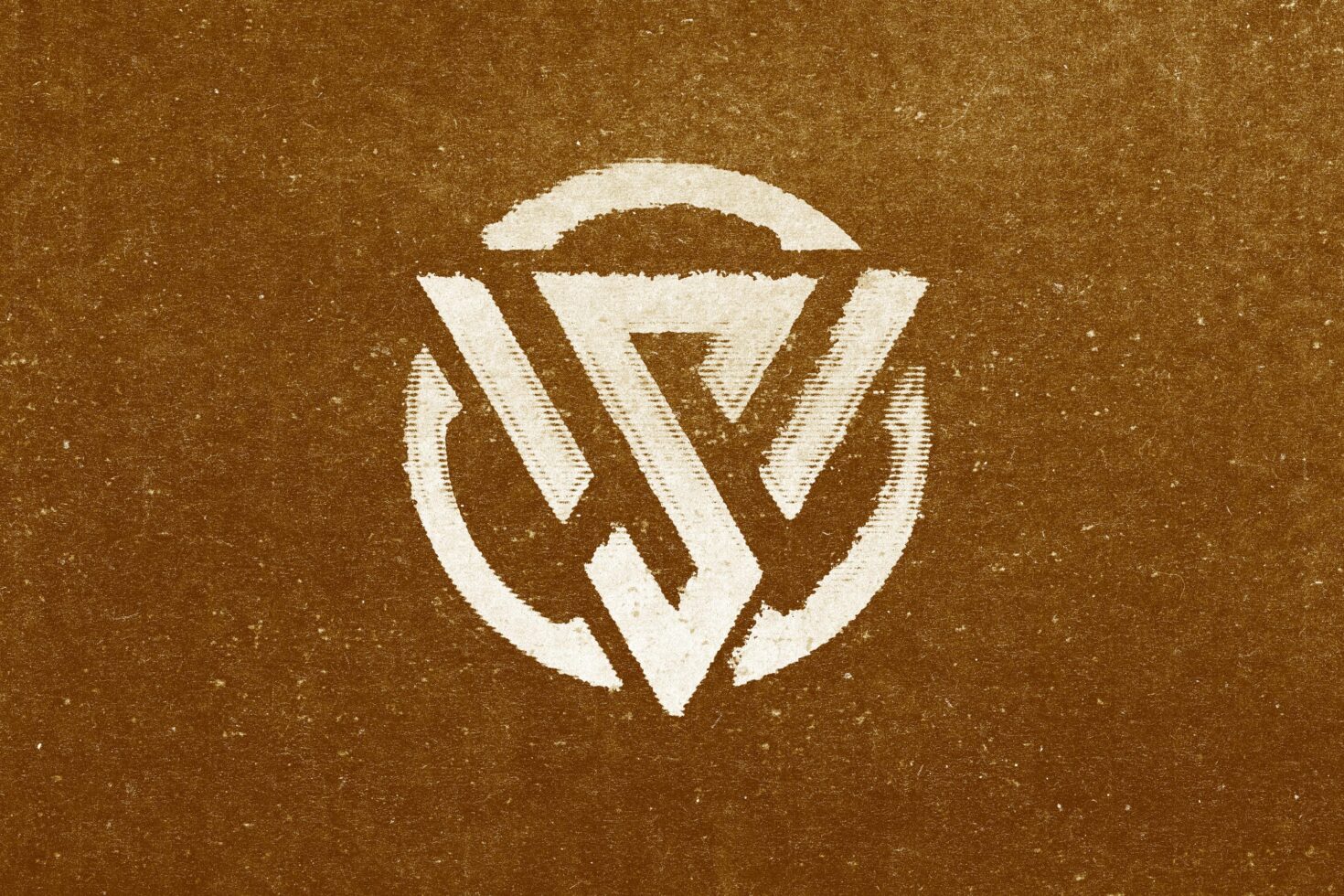 Circular badge logo with white V shape design on textured brown background