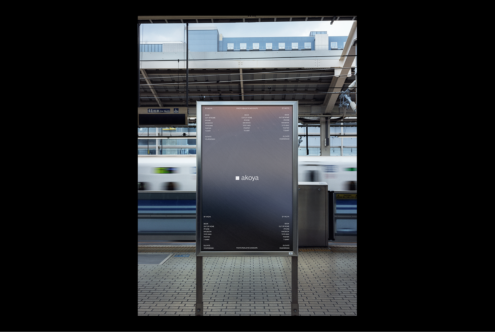 Mockup of an advertising board at a train station platform. Blurred train passing by. Ideal for showcasing signage design and urban advertising.