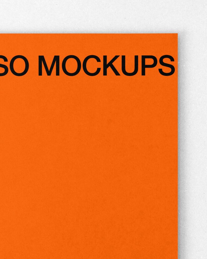 Bright orange paper sheet tilted showing black text against clean minimal background