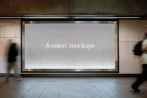 Wide horizontal billboard in tunnel showing light gray background with white text