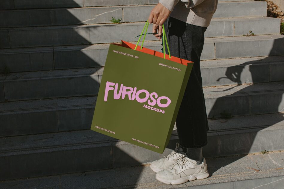 Olive shopping bag with pink Furioso text held by person in casual streetwear