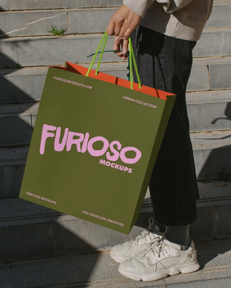 Olive shopping bag with pink Furioso Mockups text, neon green handles on concrete steps