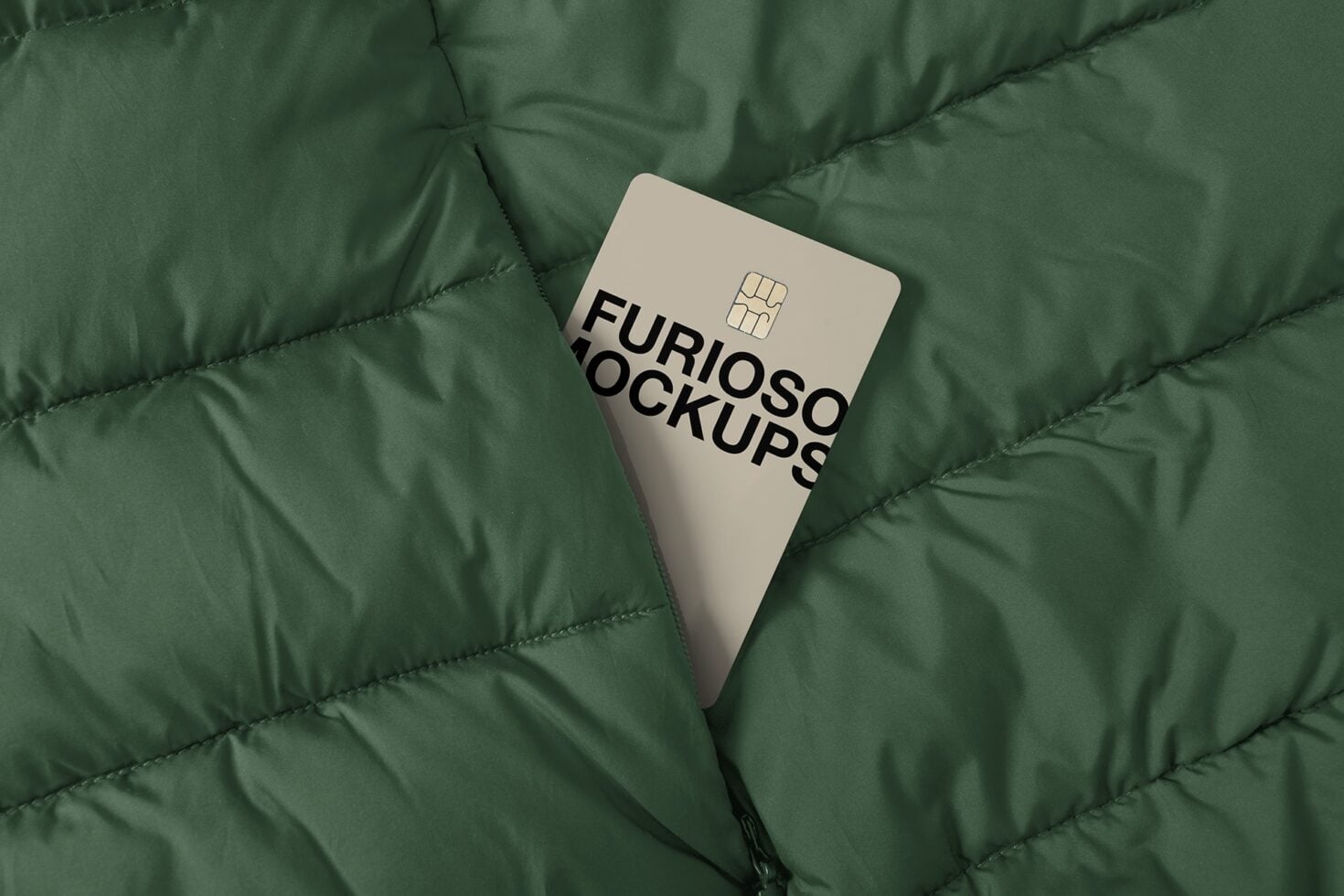 Cream colored credit card with chip on quilted green fabric background