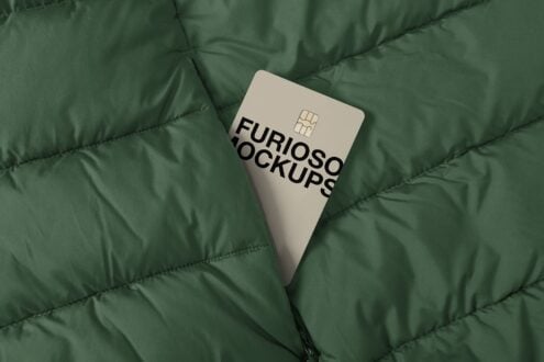 Cream colored credit card with chip on quilted green fabric background