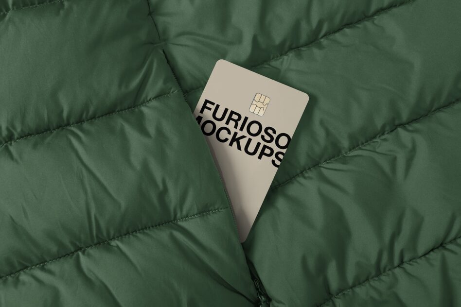 Cream colored credit card with chip on quilted green fabric background