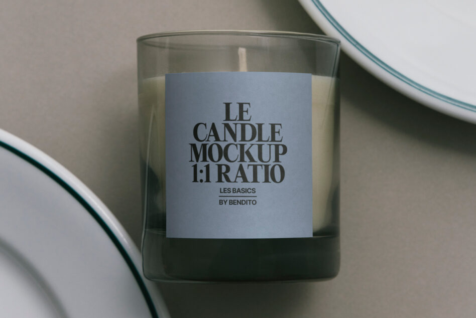 Glass candle with blue label, ceramic plate rim visible overhead