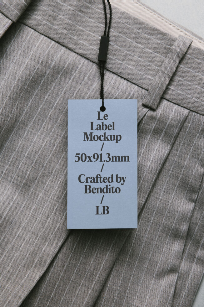 Light blue hang tag on pinstriped fabric with black cord, showing Le Label Mockup text