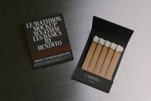Dark matchbox mockup with brown stripe shown open with striking matches, tilted arrangement