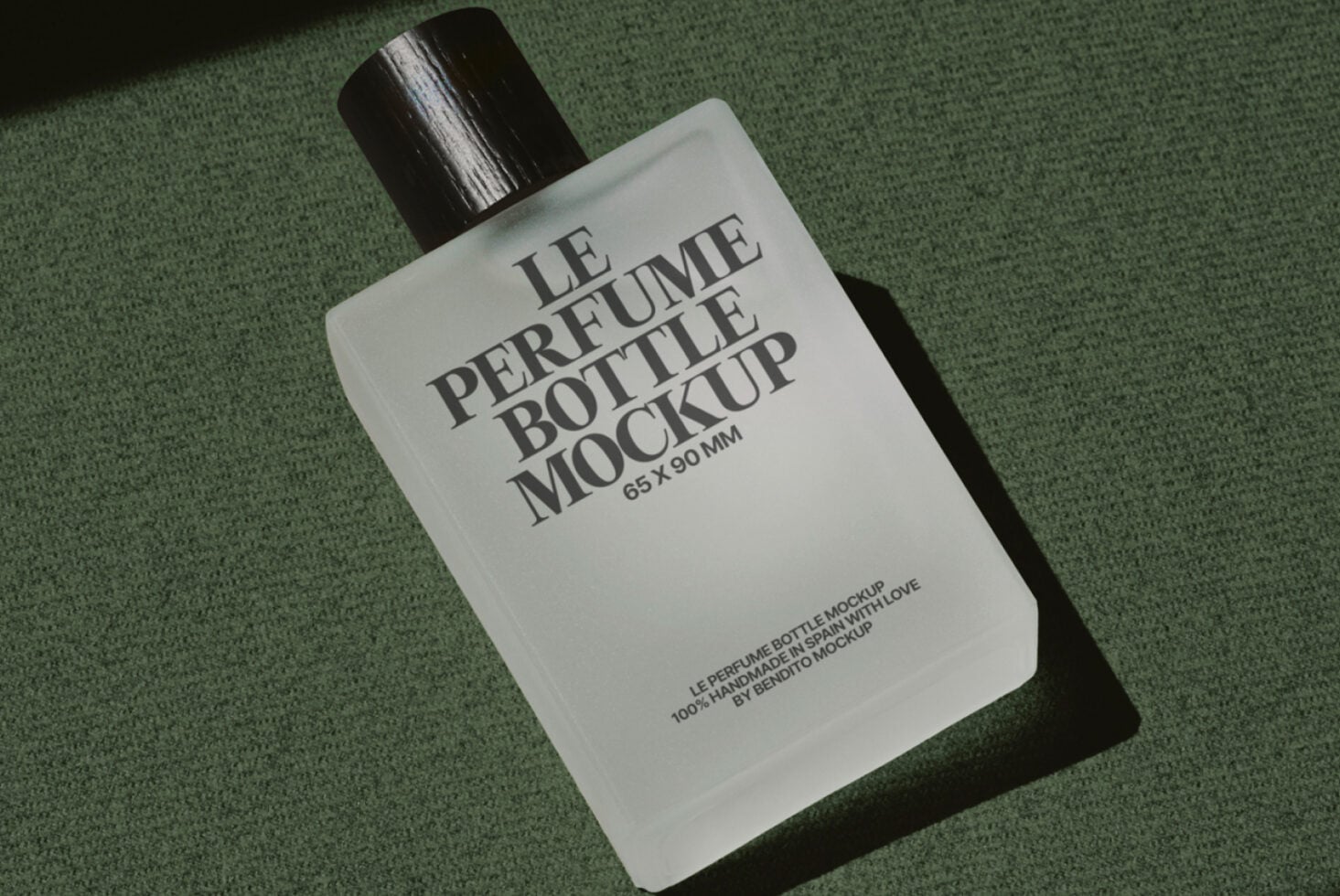 Flat lay of white rectangular perfume bottle with black atomizer on muted green fabric