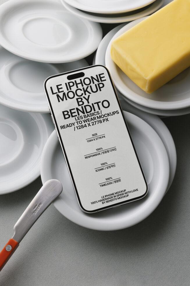 Light iPhone mockup on white plates with yellow butter, knife visible