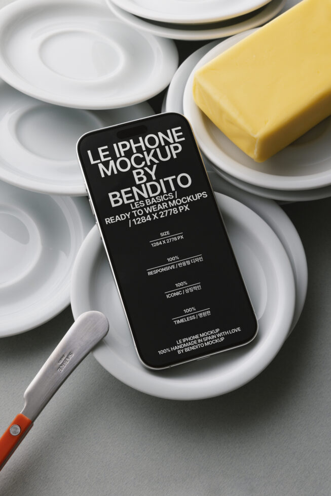 Dark iPhone mockup on white plates with yellow butter, knife visible